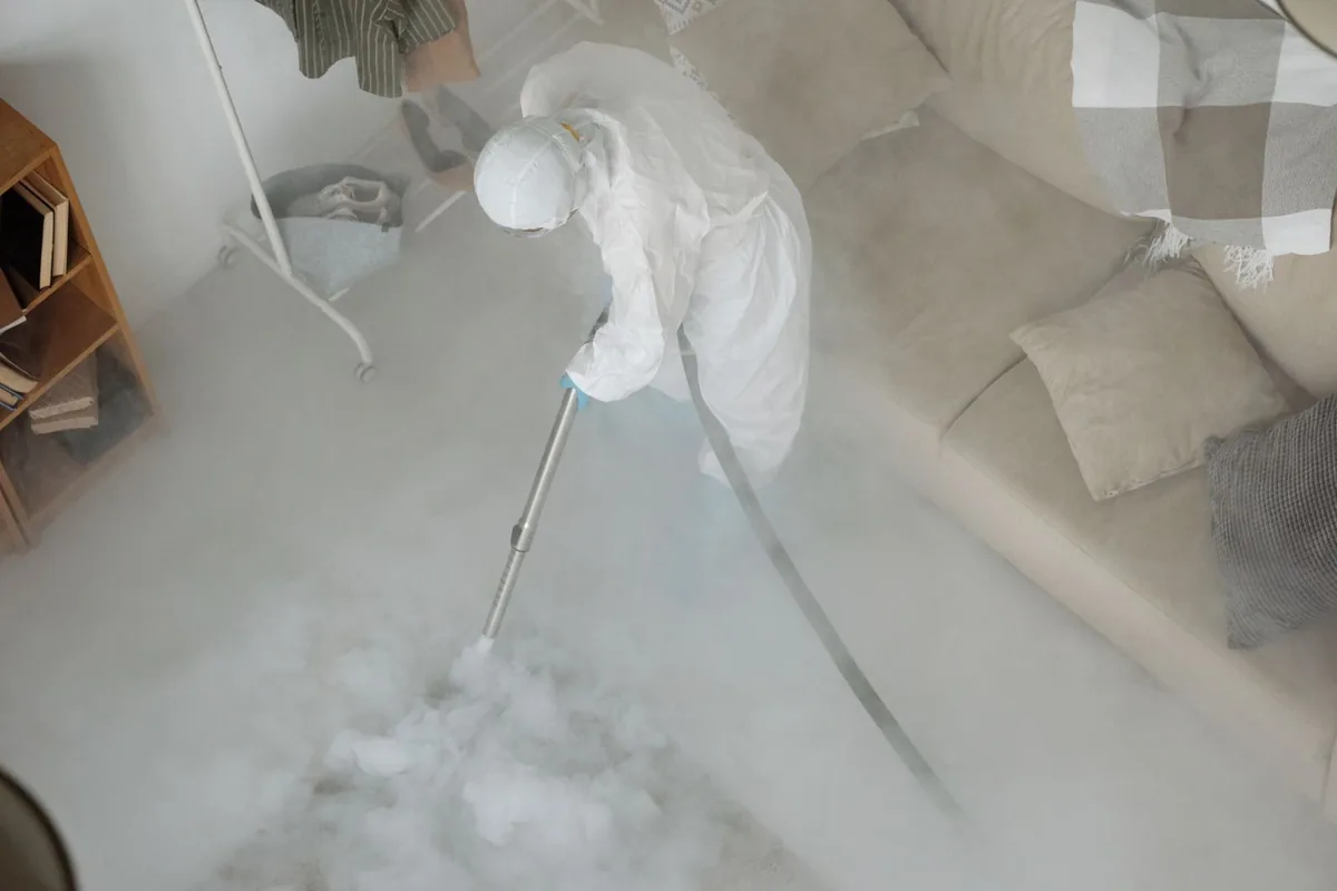 Biohazard cleanup technician in protective equipment, Stockton, KS